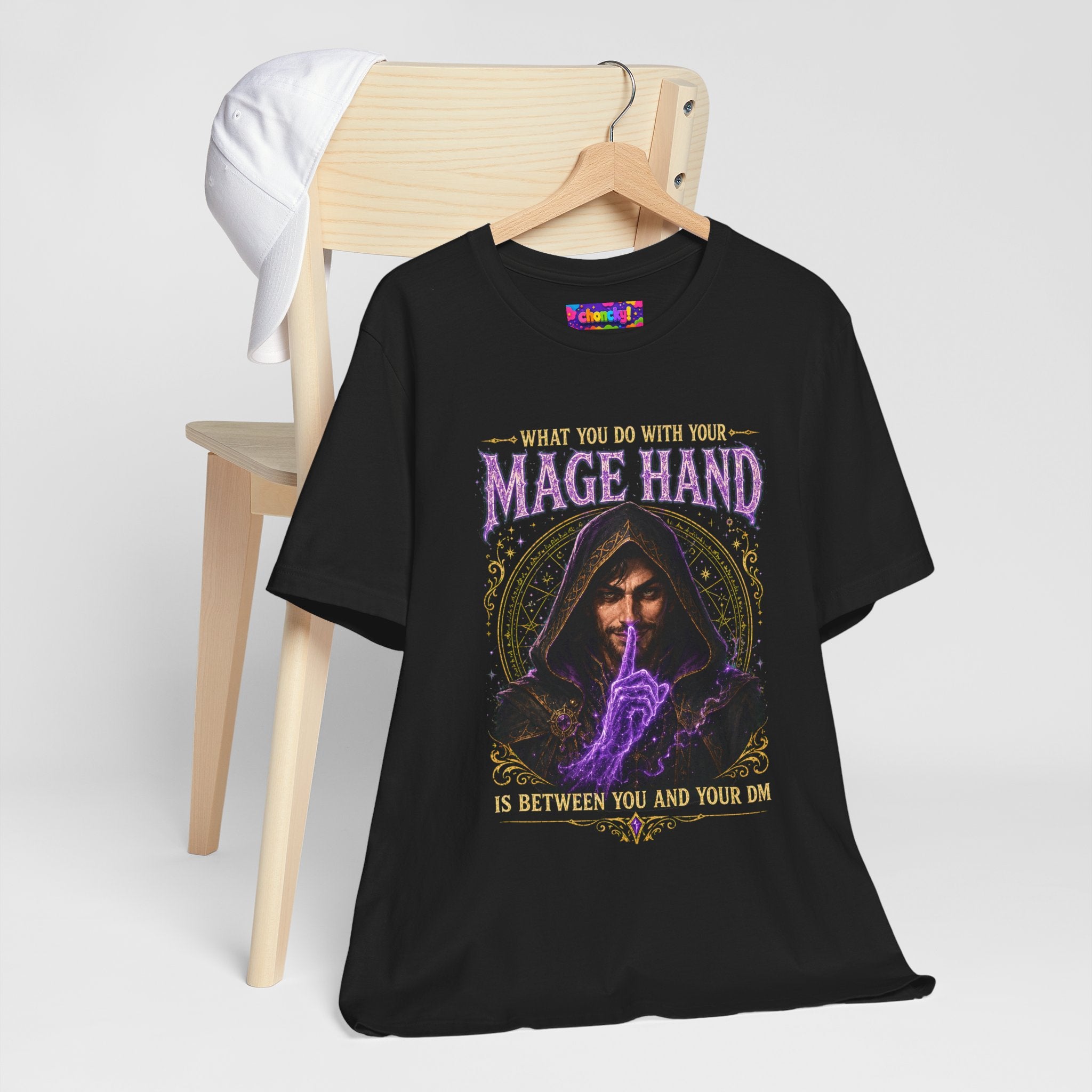 Mage Hand tabletop RPG graphic T-shirt, black shirt hanging beside a chair.